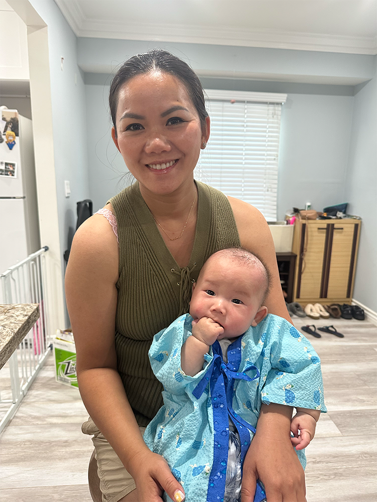 Dr Kyle Nishimura's wife holding their son